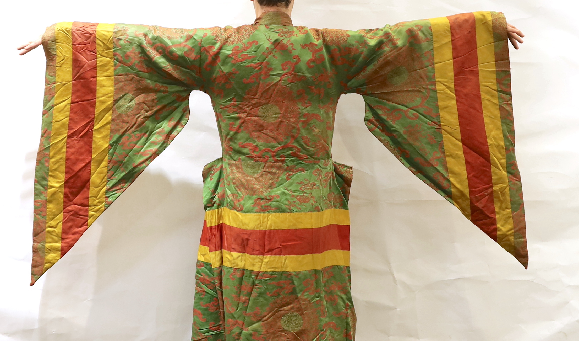 An unusual early 20th century Japanese silk damask kimono, designed with pointed sleeves and wide pleating on the hips, and horizontal yellow and red stripes, possibly a costume for a Kabuki theatre character